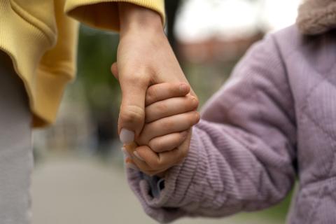 Woman and child holding hands