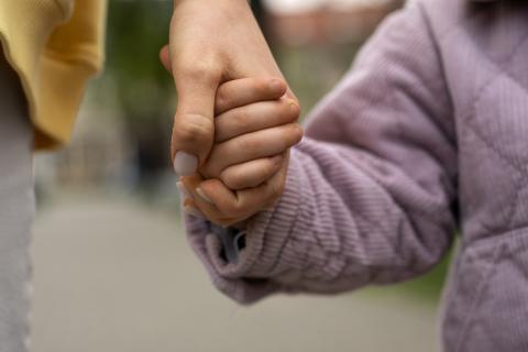Woman and child holding hands