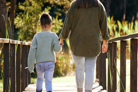 Woman and child holding hands