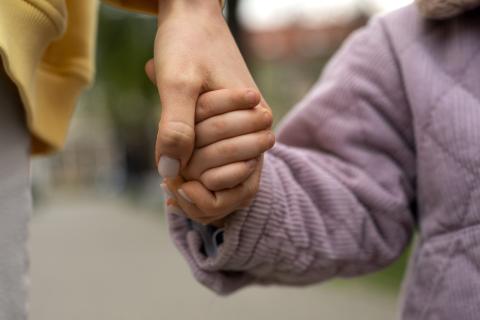Woman and child holding hands