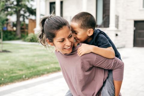 Woman carrying child on back