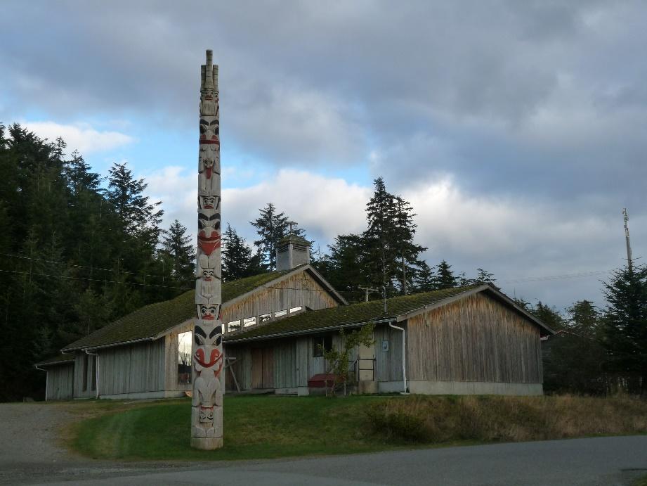 Building with a totem pole in front