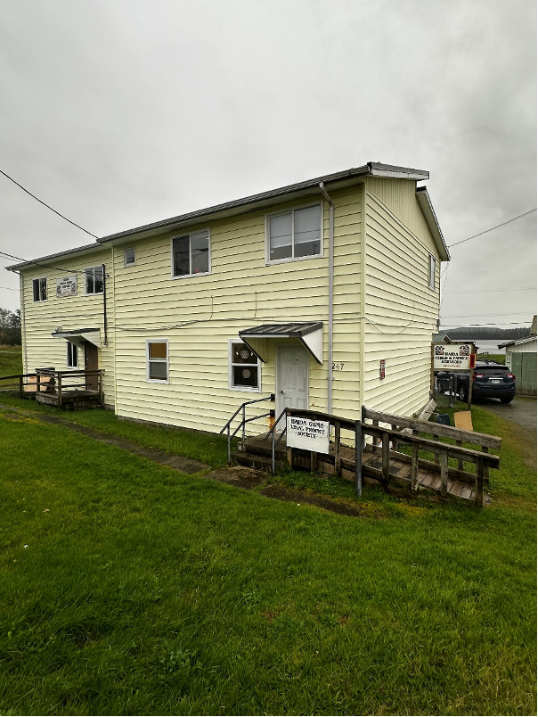 Yellow building with door, stairs and a ramp