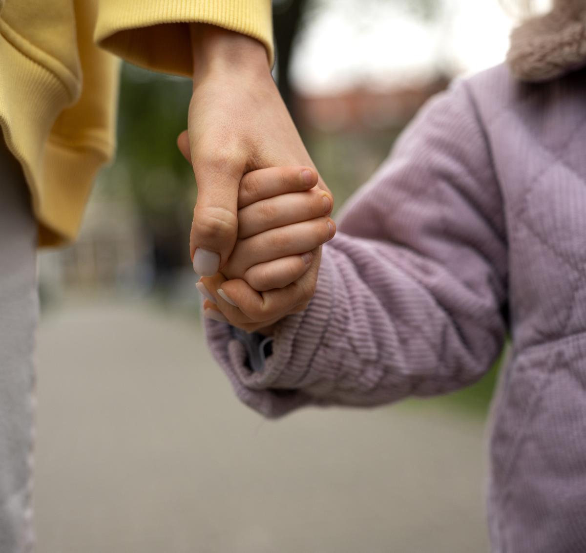 Woman and child holding hands