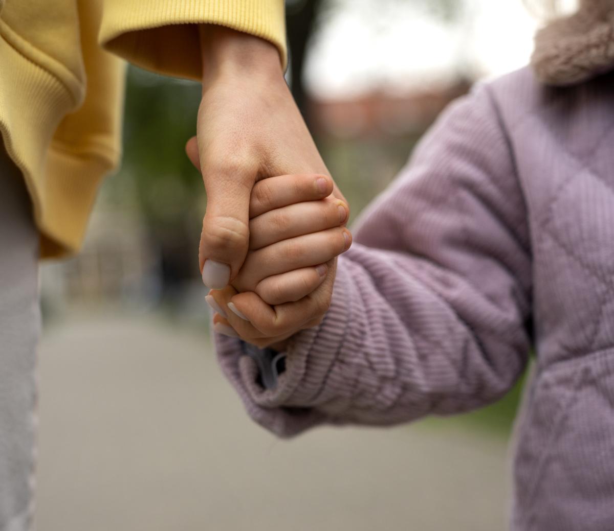 Woman and child holding hands