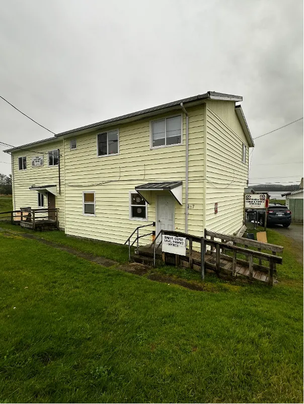 Yellow building with door, stairs and a ramp